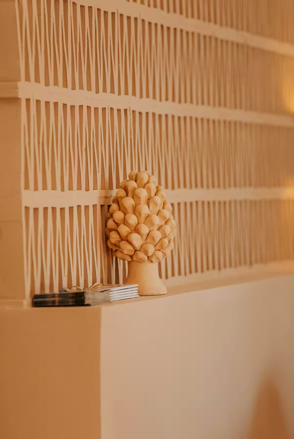 Villa Syba, decorative detail — moucharabieh wall and ceramic pinecone